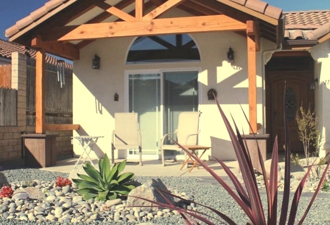 A small concrete front porch in the style of the Tuscany is shown here.